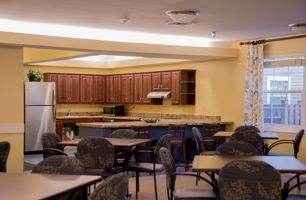 a dining room and kitchen with tables and chairs