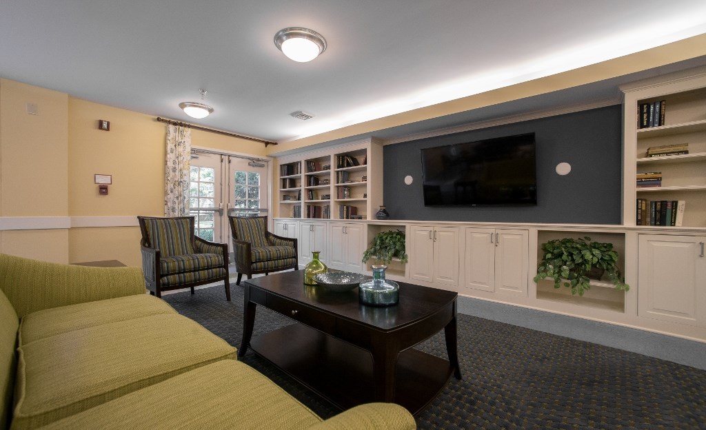 a living room with a couch and chairs and a television