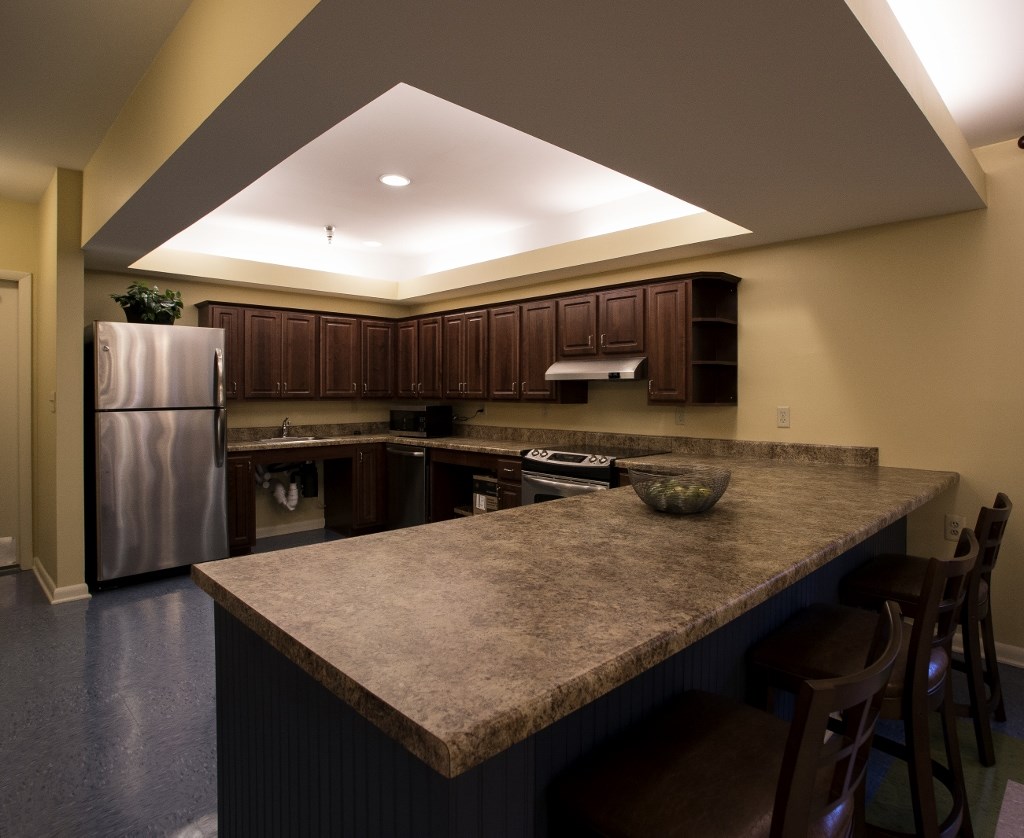 a kitchen with a large island and stainless steel appliances