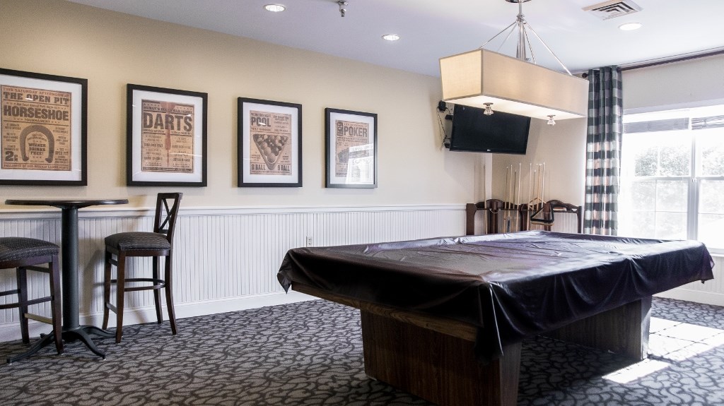 a conference room with a projector screen and a table with a black cloth on it