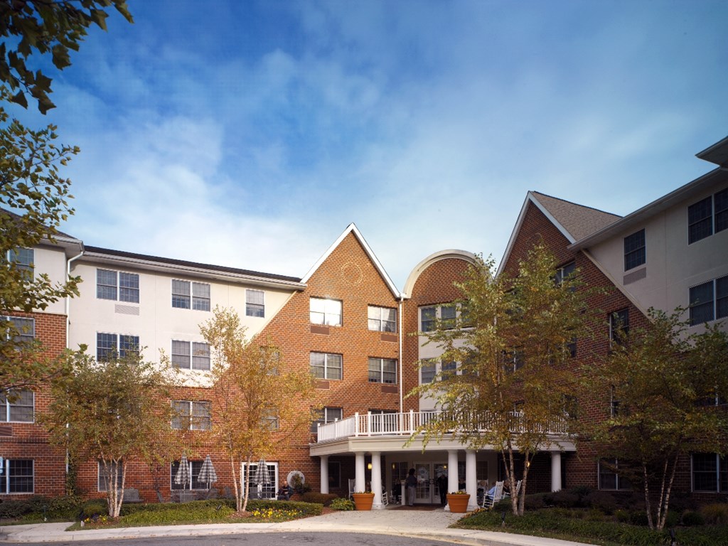a large brick building with trees in front of it