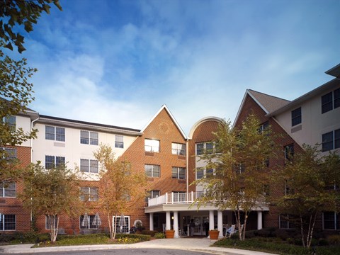 a large brick building with trees in front of it