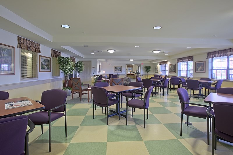 a dining room with tables and chairs and a checkered floor