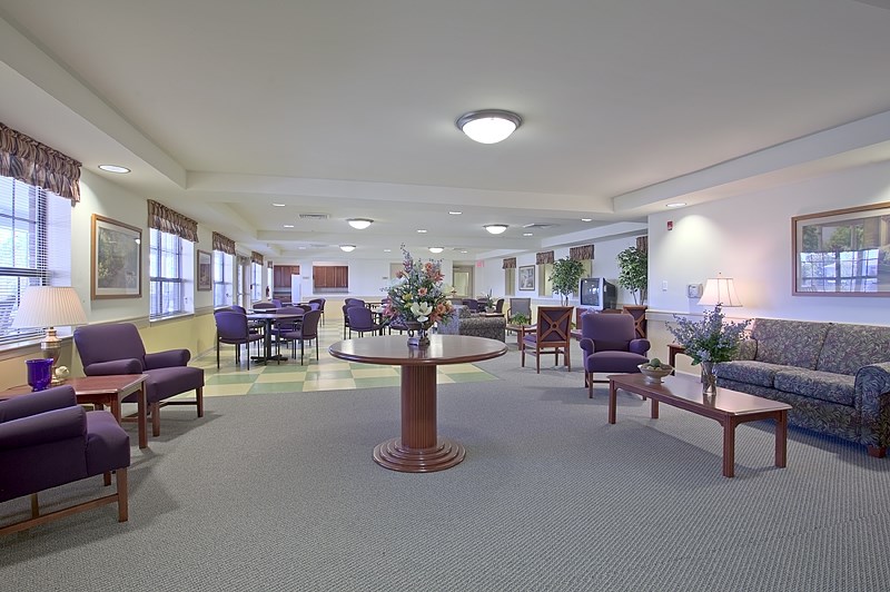 a lobby with couches tables and chairs and a table in the middle