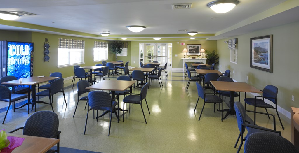 a dining room with tables and chairs in a multipurpose room