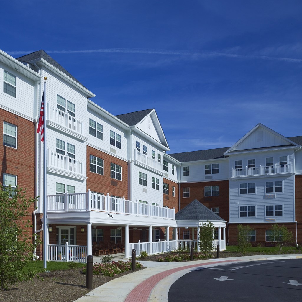 an exterior view of an apartment building with an flag