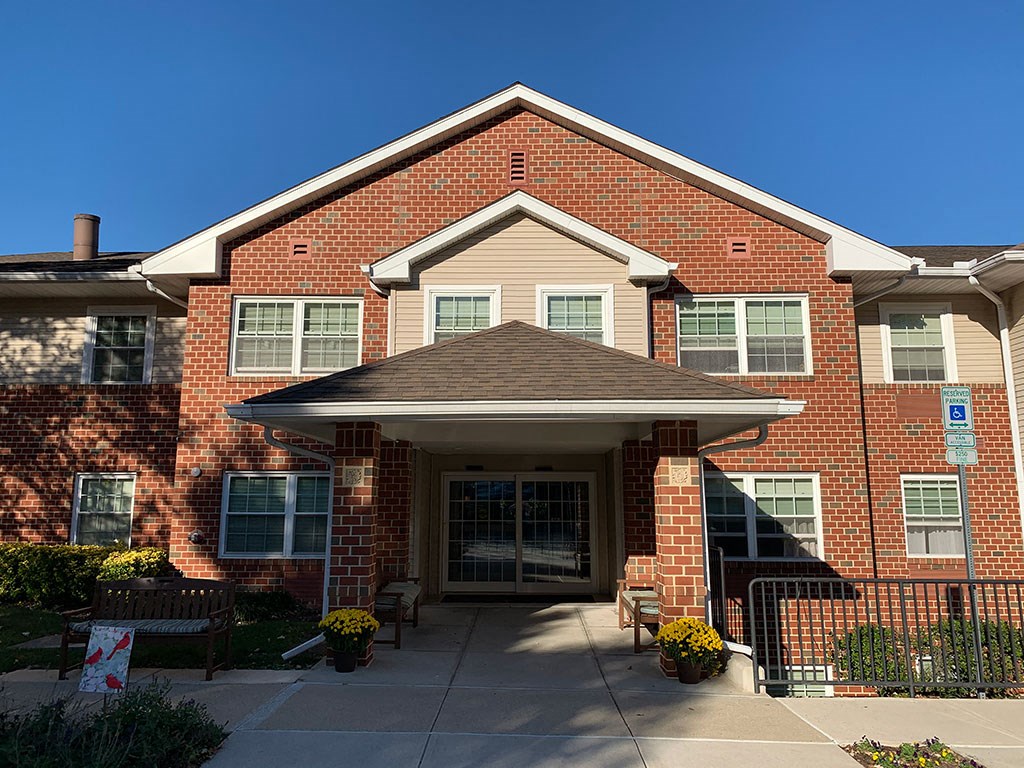 the front of a brick house with a porch