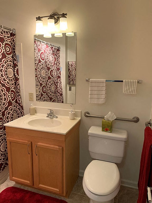 a bathroom with a toilet and a sink and a mirror