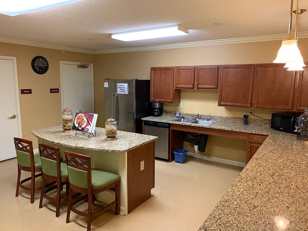 a kitchen with a bar and a counter top