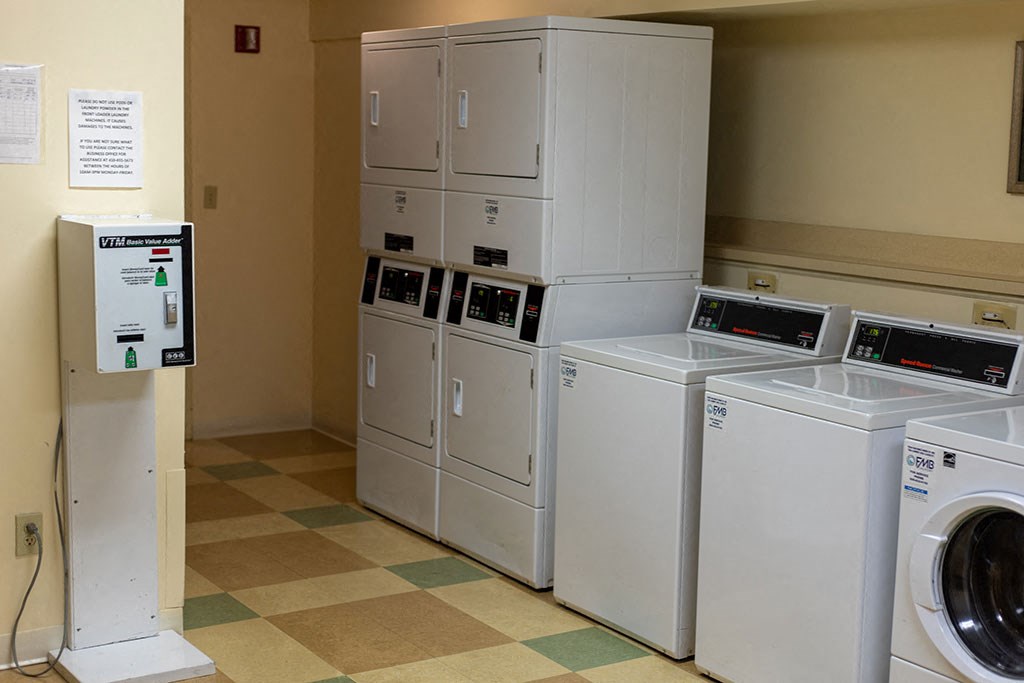 On-site laundry facility at Park View at Randallstown with multiple washers and dryers, providing convenient and accessible laundry options for senior residents.