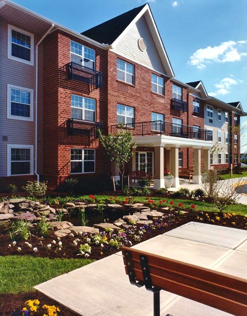 a large brick building with a sidewalk in front of it