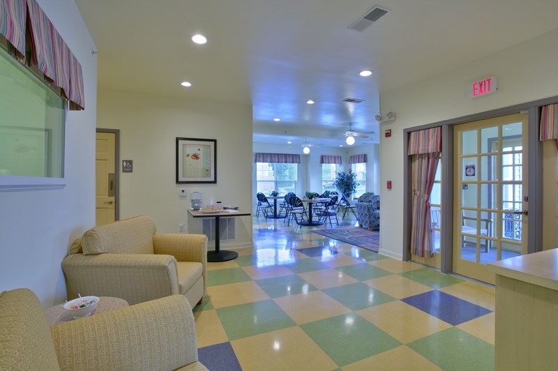 a living room with couches and chairs and a checkered floor