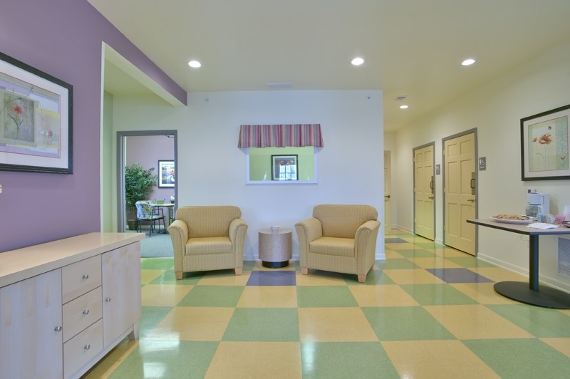 a waiting room with two chairs and a coffee table