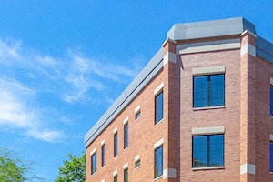 a brick building with a car parked in front of it