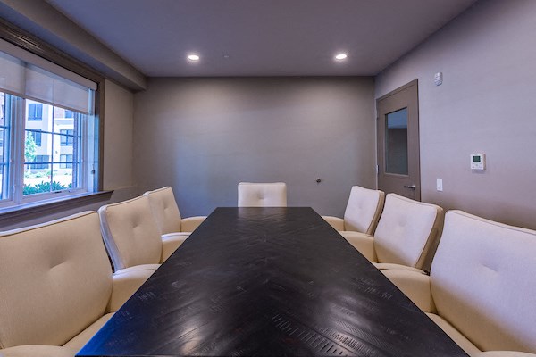 a conference room with a table and chairs and a window