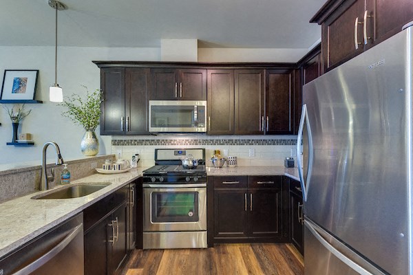 a kitchen with stainless steel appliances and wooden cabinets