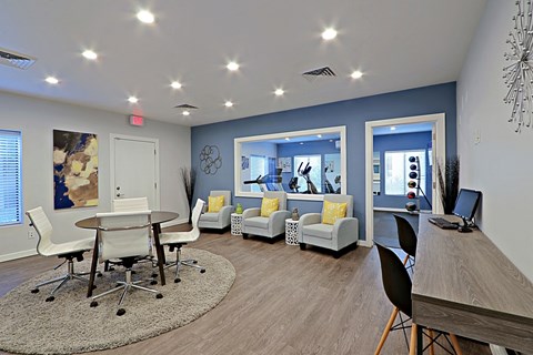 a living room and dining room with a table and chairs
