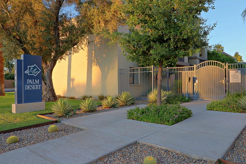 a building with a sign and trees in front of it