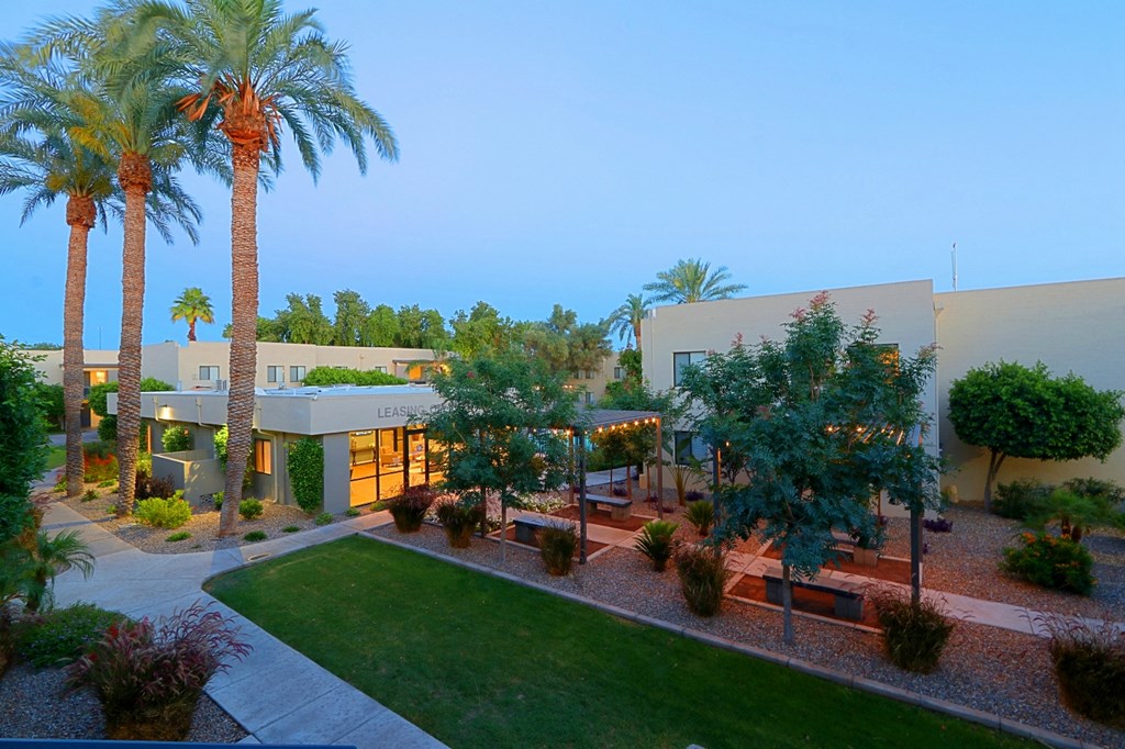 an aerial view of a house with a yard and palm trees