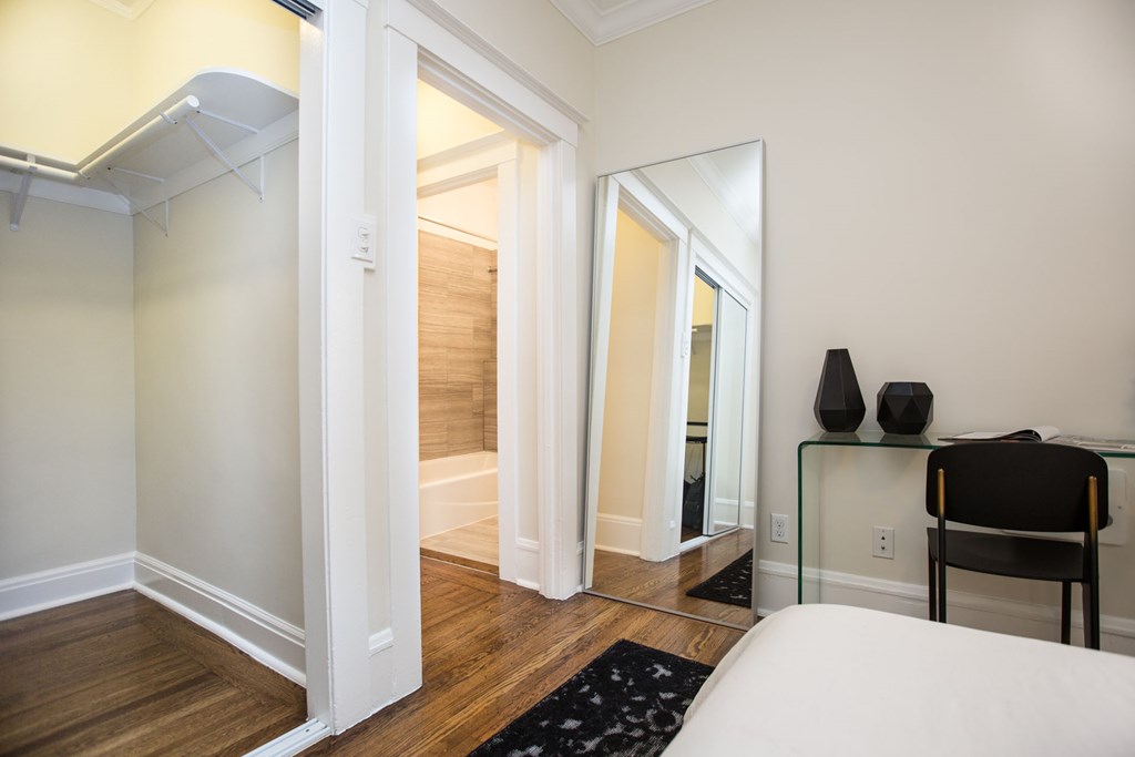 a bedroom with a bed and a mirror