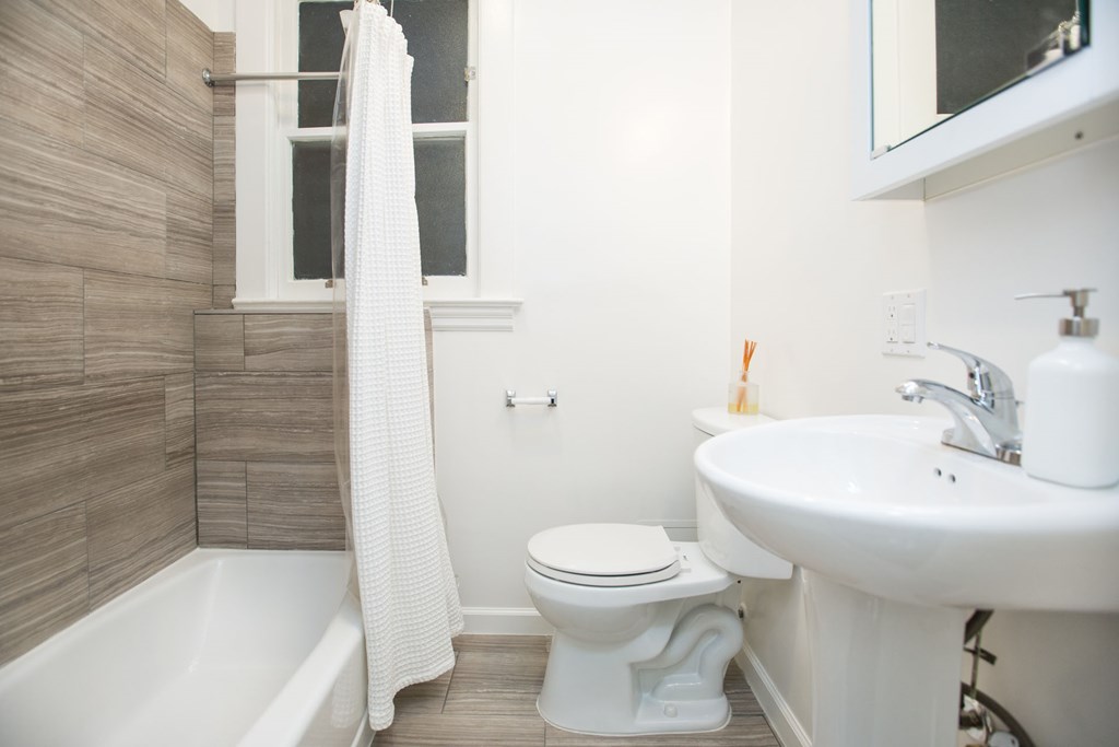 a bathroom with a sink toilet and bath tub