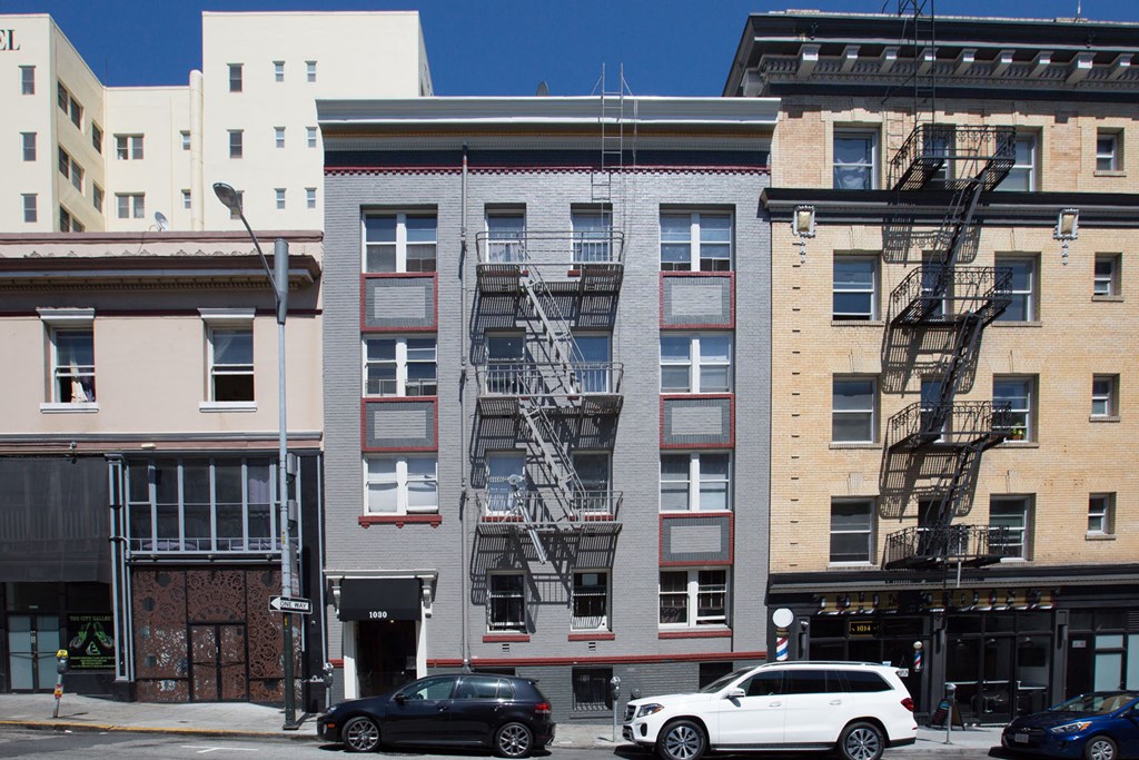 a building with a fire escape on the side of a street