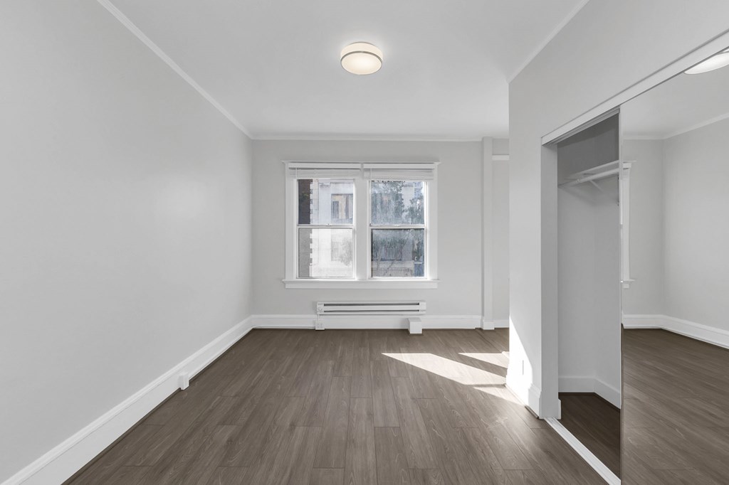 a living room with white walls and a window