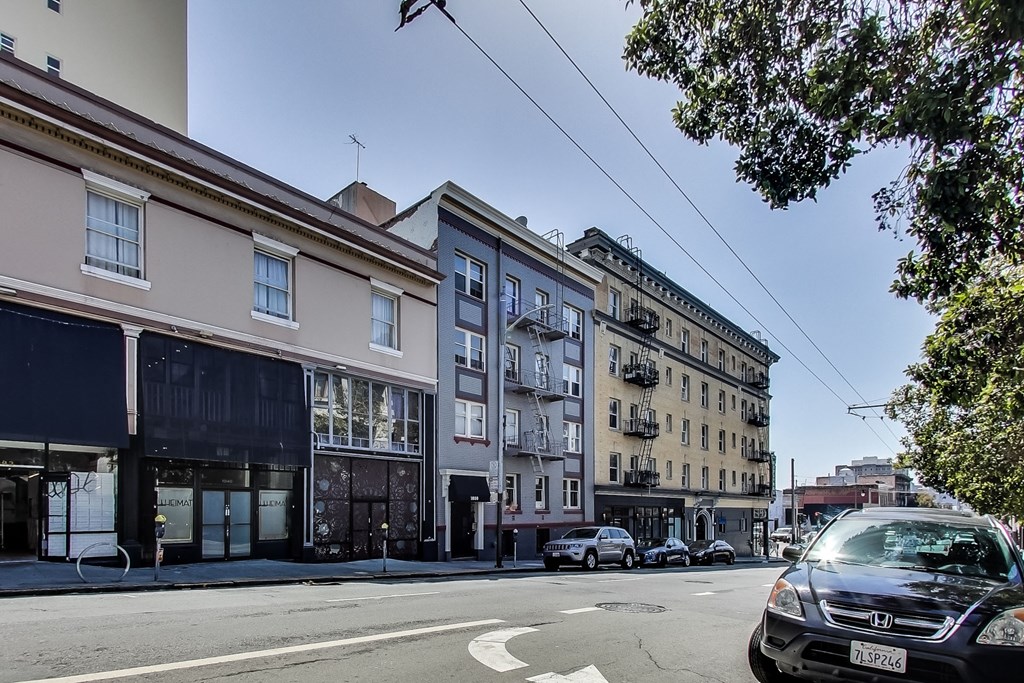 a city street with tall buildings and cars on it