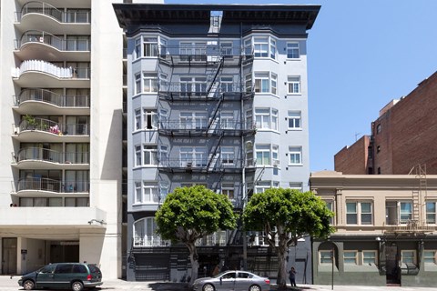 A white building with a fire escape on the side.