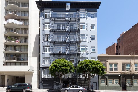 A white building with a fire escape on the side.