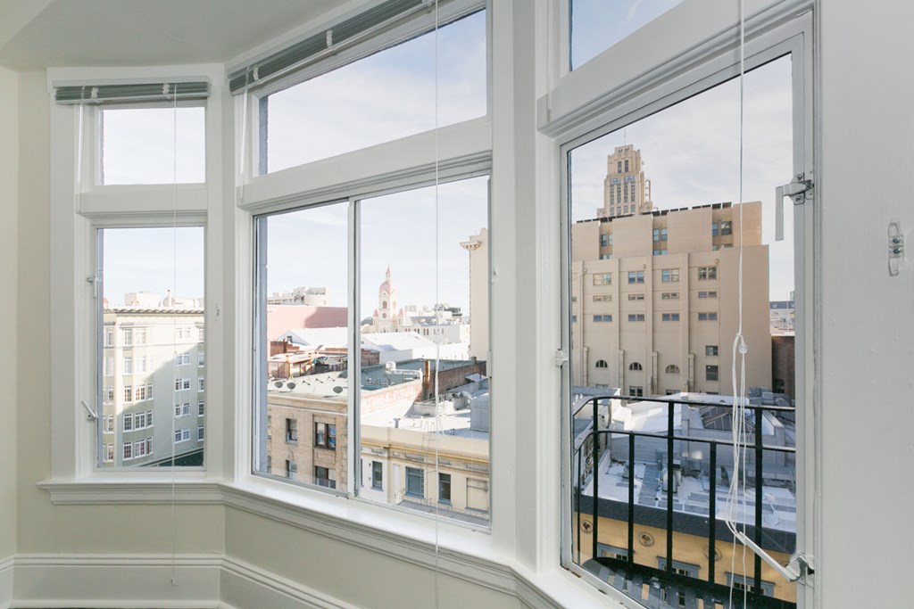 the view of the city from the windows of a bedroom
