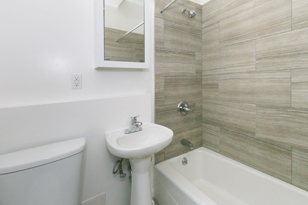 a small bathroom with a sink toilet and shower