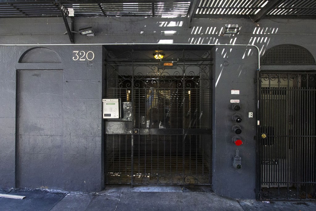 a door to a jail cell with a metal gate