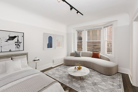 A bedroom with a large bed and a couch.