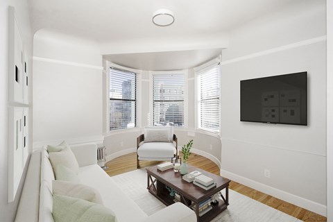 A living room with a white couch and a wooden coffee table.