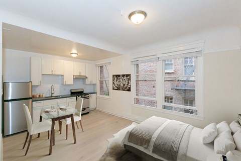 A kitchen with a table and chairs.