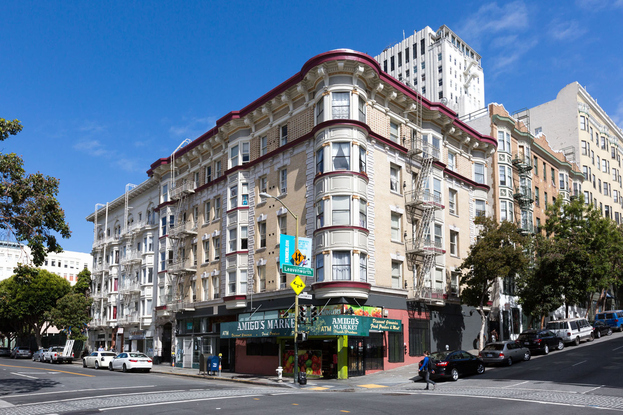 A street view of a city with a building in the middle.