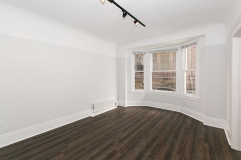 A room with wooden floors and white walls.
