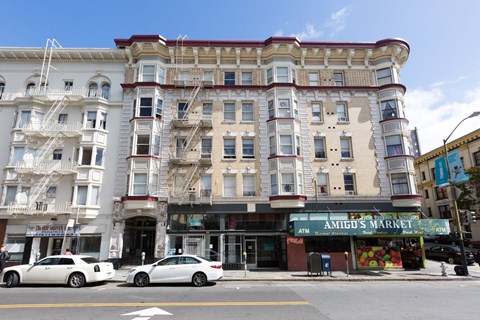 A street view of a building with a sign that says "AMIGO'S MARKET".