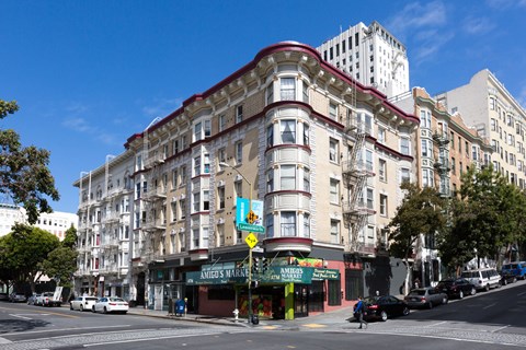 A street view of a city with a building in the middle.