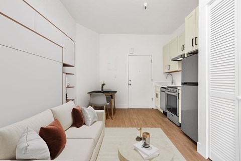 A modern living room with a white couch and a coffee table.
