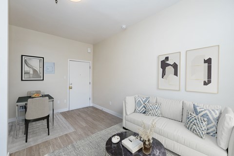 A living room with a white couch and a coffee table.