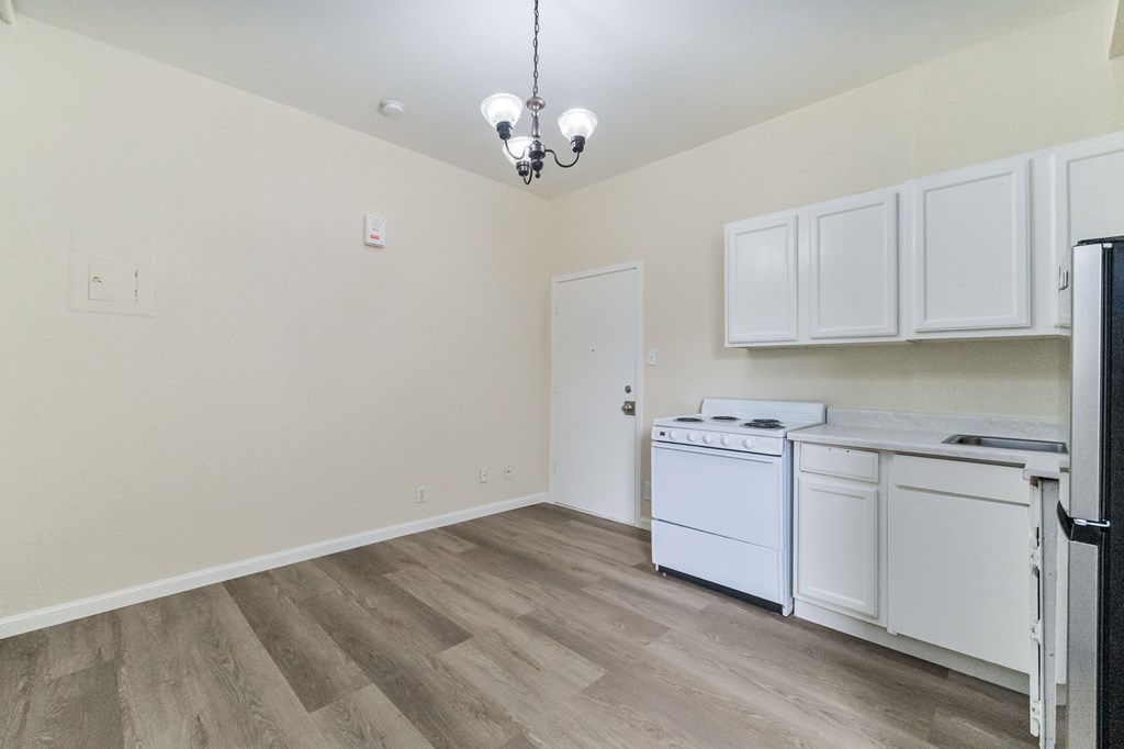A kitchen with white appliances and cabinets.