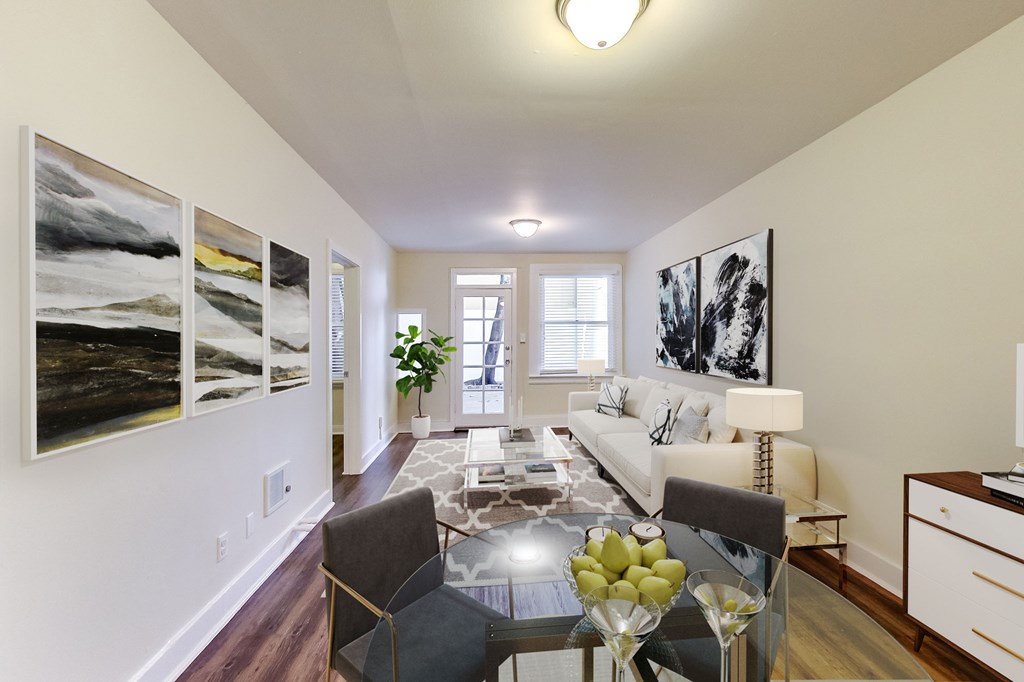 a living room with a glass table and a couch