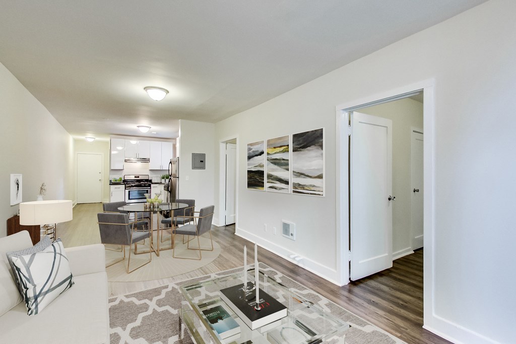 a living room and dining room with a table and chairs