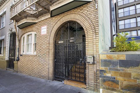 A building with a black gate and a brick facade.