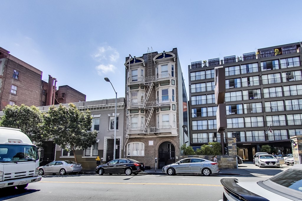 a building with a fire escape on a city street