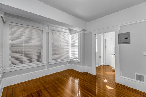 A room with wooden floors and white walls.