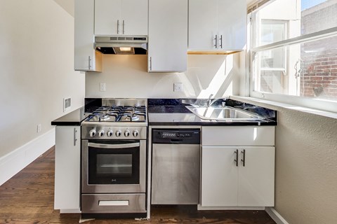 A modern kitchen with a stove and sink.