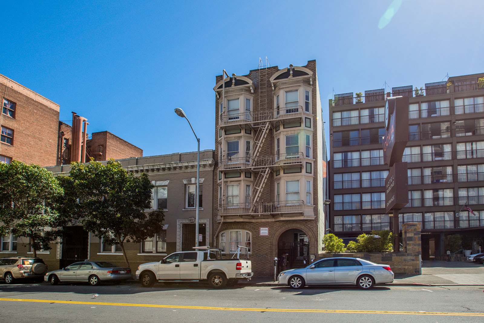 A street view of a city with cars and buildings.